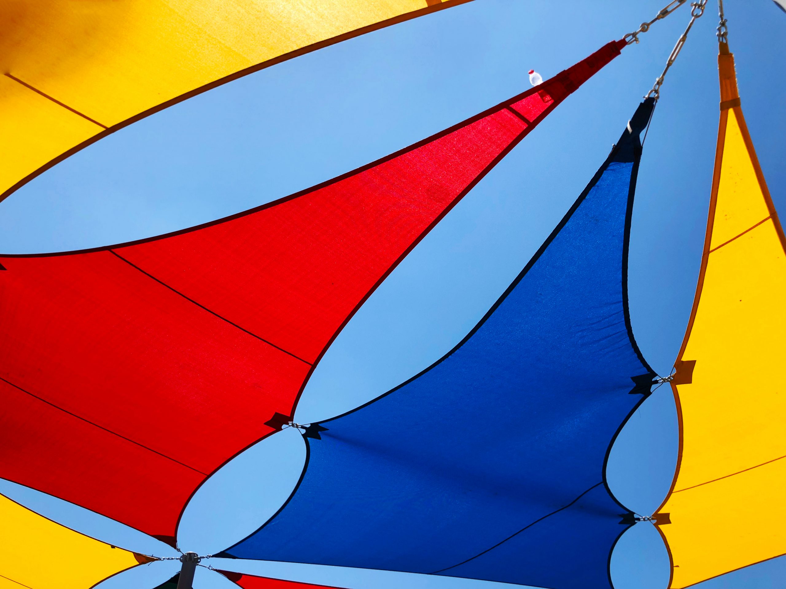 Custom shade sails in red, blue and yellow